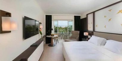 comfortable king room with TV and outdoor terrace at Hilton Nicosia.