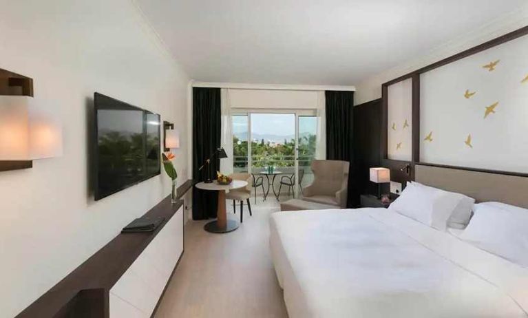 comfortable king room with TV and outdoor terrace at Hilton Nicosia.