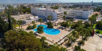 stunning outdoor pool surrounded with sunbeds and umbrellas at Hilton Nicosia.