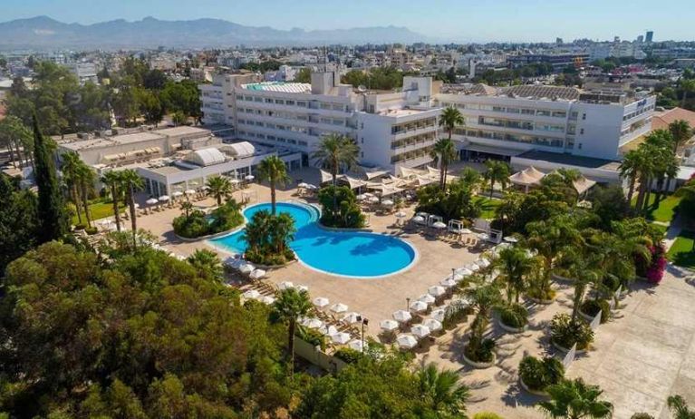 stunning outdoor pool surrounded with sunbeds and umbrellas at Hilton Nicosia.