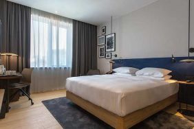 spacious king room with TV, work desk, and chair at Hilton Garden Inn Zagreb - Radnicka.