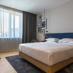 spacious king room with TV, work desk, and chair at Hilton Garden Inn Zagreb - Radnicka.