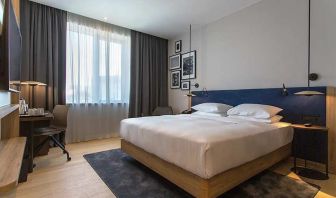 spacious king room with TV, work desk, and chair at Hilton Garden Inn Zagreb - Radnicka.