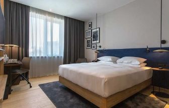 spacious king room with TV, work desk, and chair at Hilton Garden Inn Zagreb - Radnicka.
