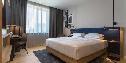 spacious king room with TV, work desk, and chair at Hilton Garden Inn Zagreb - Radnicka.