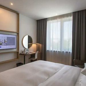 comfortable king suite with TV, work desk, and chair at Hilton Garden Inn Zagreb - Radnicka.