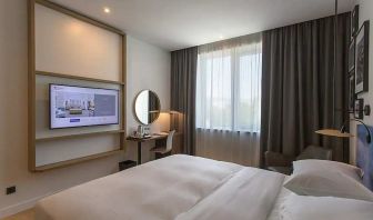 comfortable king suite with TV, work desk, and chair at Hilton Garden Inn Zagreb - Radnicka.