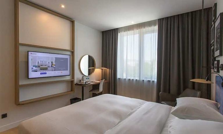 comfortable king suite with TV, work desk, and chair at Hilton Garden Inn Zagreb - Radnicka.