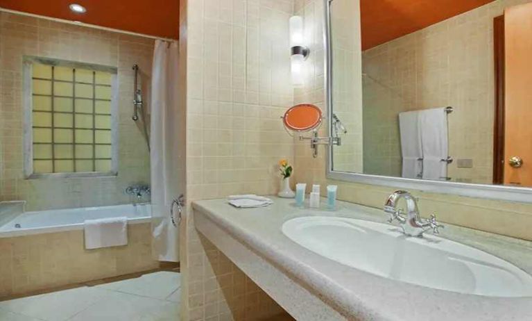 clean and spacious king bathroom with shower and bath combo at Hilton Alexandria Green Plaza.