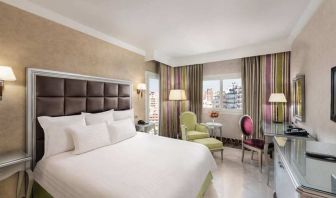 spacious king room with TV, desk, chair, and couch at Hilton Alexandria Corniche.