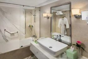 clean and spacious king bathroom with shower and bath combo at Hilton Alexandria Corniche.