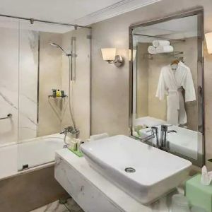 clean and spacious king bathroom with shower and bath combo at Hilton Alexandria Corniche.