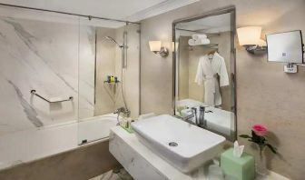 clean and spacious king bathroom with shower and bath combo at Hilton Alexandria Corniche.