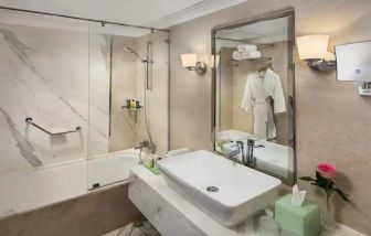 clean and spacious king bathroom with shower and bath combo at Hilton Alexandria Corniche.