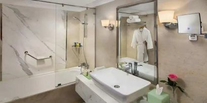 clean and spacious king bathroom with shower and bath combo at Hilton Alexandria Corniche.