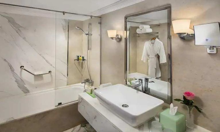 clean and spacious king bathroom with shower and bath combo at Hilton Alexandria Corniche.