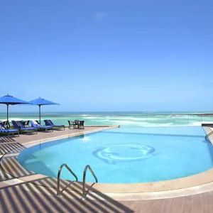 stunning outdoor pool with sunbeds and umbrellas at Hilton Alexandria Corniche.