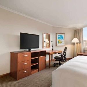 spacious king suite with TV, desk, chair, and couch at Hilton Colon Quito.