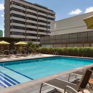 stunning outdoor pool with sunbeds and umbrellas at Hilton Colon Quito.