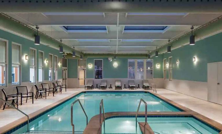 relaxing indoor pool with seating area at Hilton Richmond Downtown.