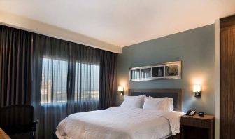 comfortable king suite with desk and chair at Hampton Inn & Suites by Hilton Salamanca Bajio.