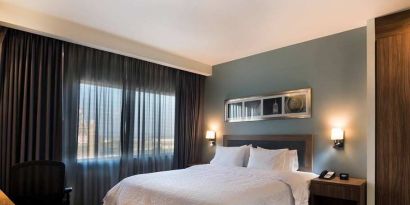 comfortable king suite with desk and chair at Hampton Inn & Suites by Hilton Salamanca Bajio.