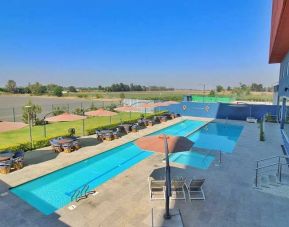 stunning outdoor pool surrounded with sunbeds at Hampton Inn & Suites by Hilton Salamanca Bajio.