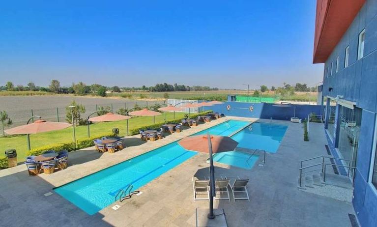 stunning outdoor pool surrounded with sunbeds at Hampton Inn & Suites by Hilton Salamanca Bajio.