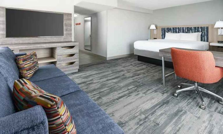 luxurious king suite with lounge and work area at Hampton Inn & Suites Tampa-Ybor City/Downtown.