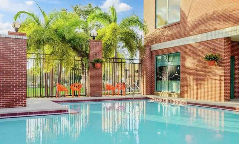 relaxing outdoor pool with seating area at Hampton Inn & Suites Tampa-Ybor City/Downtown.