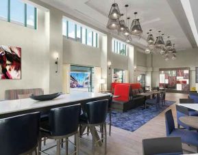 spacious lounge, lobby, coworking space with lots of natural light ideal for doing work online at Hampton Inn & Suites Tampa-Ybor City/Downtown.