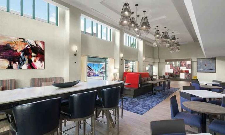 spacious lounge, lobby, coworking space with lots of natural light ideal for doing work online at Hampton Inn & Suites Tampa-Ybor City/Downtown.