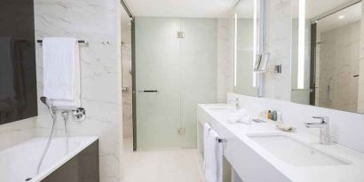 clean and spacious king bathroom with shower and bath at Hilton Tallinn Park.