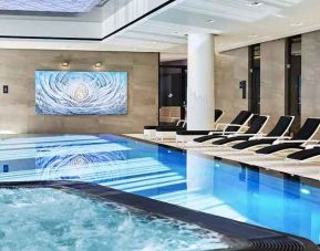 stunning indoor pool with sunbeds at Hilton Tallinn Park.