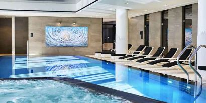 stunning indoor pool with sunbeds at Hilton Tallinn Park.