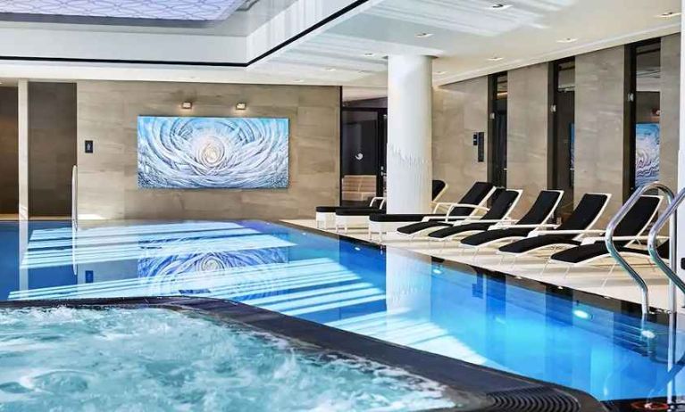 stunning indoor pool with sunbeds at Hilton Tallinn Park.