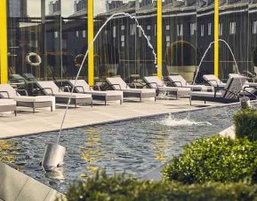beautiful rooftop terrace with pool-fountain and sunbeds at Hilton Tallinn Park.