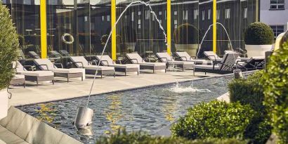 beautiful rooftop terrace with pool-fountain and sunbeds at Hilton Tallinn Park.