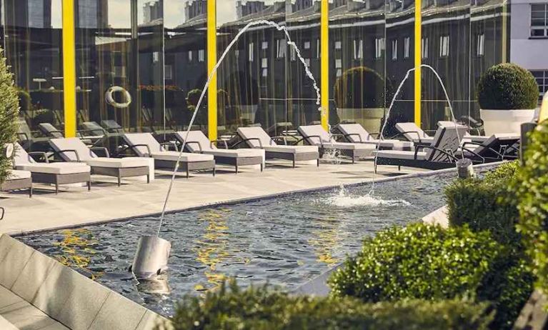 beautiful rooftop terrace with pool-fountain and sunbeds at Hilton Tallinn Park.