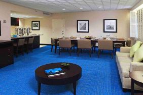 Hotel workspace with sofa and table at Miami International Airport Hotel.