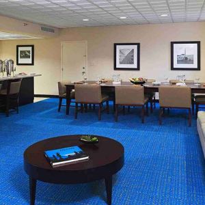 Hotel workspace with sofa and table at Miami International Airport Hotel.