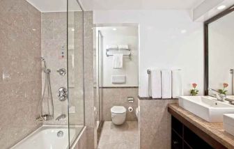 clean and spacious king bathroom with shower and bath at Hilton Cairo Heliopolis.