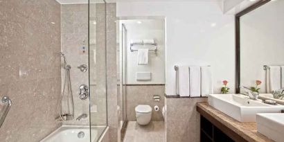 clean and spacious king bathroom with shower and bath at Hilton Cairo Heliopolis.