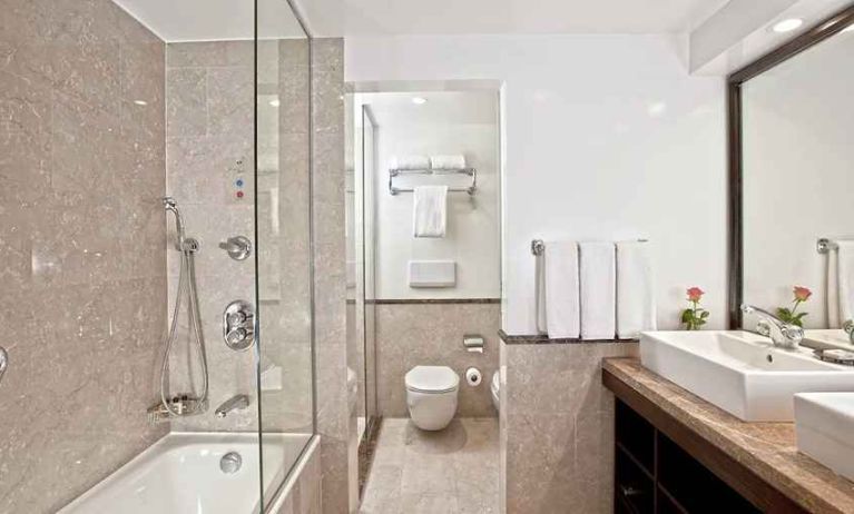 clean and spacious king bathroom with shower and bath at Hilton Cairo Heliopolis.