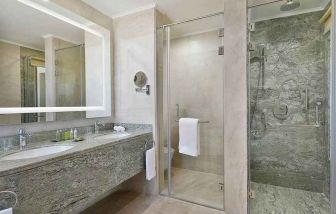 clean and spacious king bathroom with shower at Hilton Hurghada Plaza.