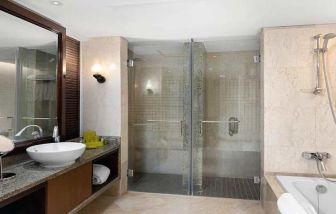 clean and spacious king bathroom with shower and bath at Hilton Luxor Resort & Spa.