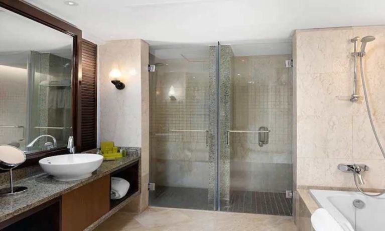 clean and spacious king bathroom with shower and bath at Hilton Luxor Resort & Spa.