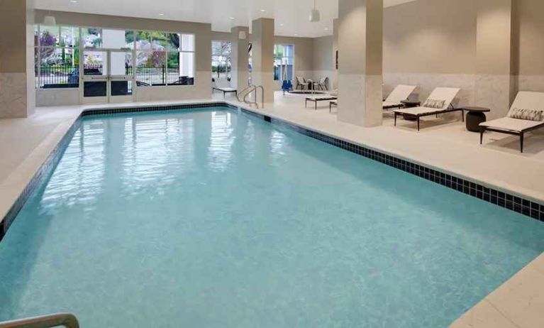 Gorgeous indoor pool with sun beds and seating at Embassy Suites by Hilton San Rafael Marin County.