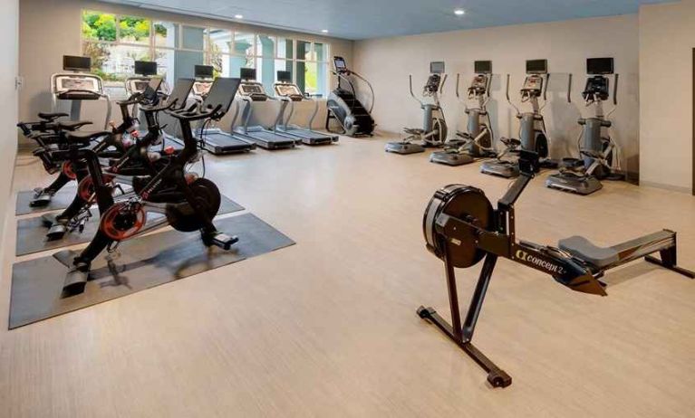 well-equipped fitness center with natural light at Embassy Suites by Hilton San Rafael Marin County.