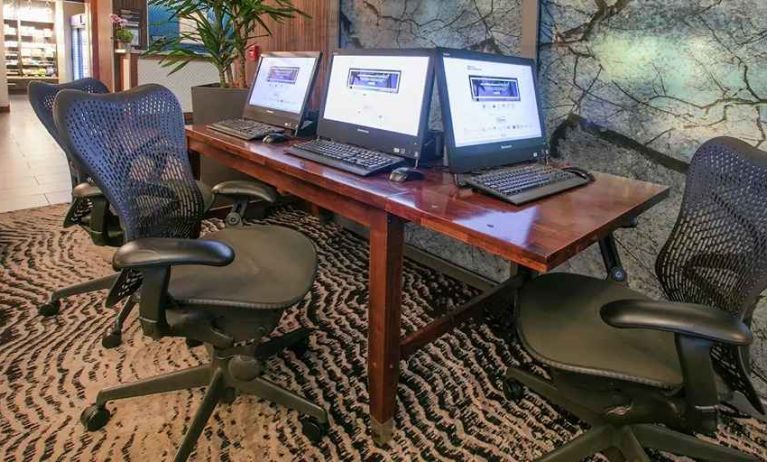 Business center with computers at the Hilton Garden Inn Seattle Downtown .